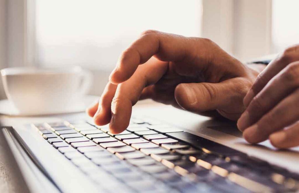 Typing on a laptop at work.