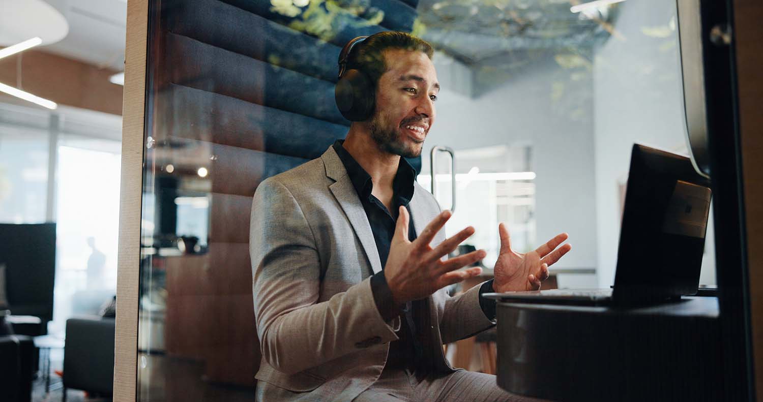 Hybrid working employee hosting a video call in private booth