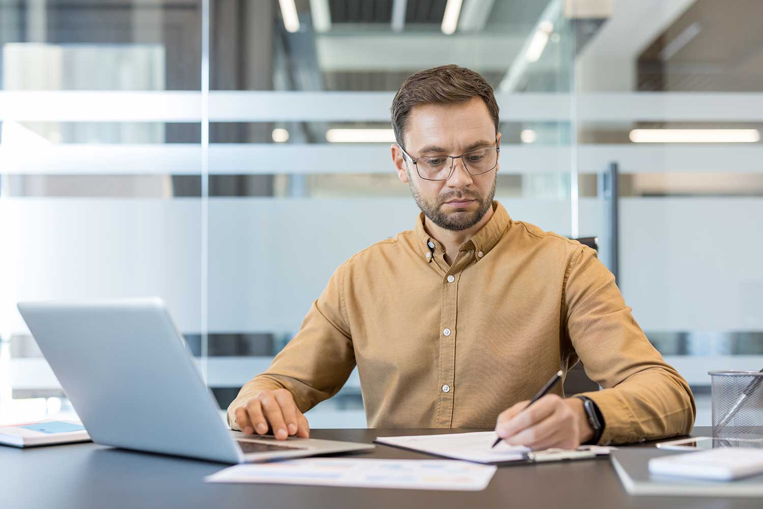 Colleague checking M365 settings on laptop